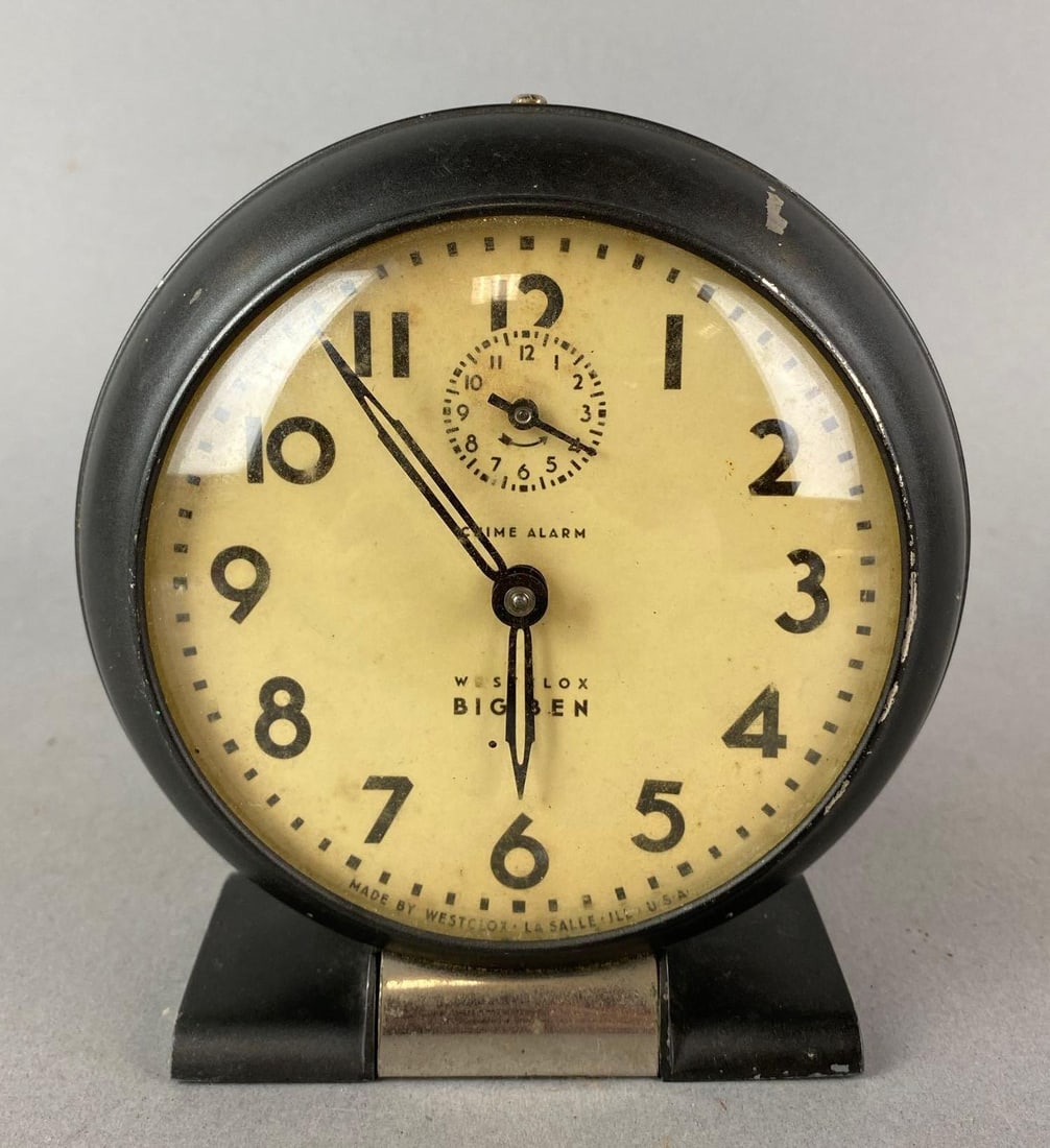 Vintage Wes Clox Windup Alarm Clock: Has some chipped paint. Missing a knob. Measures 5 3/4 x 5 1/4 x 2 1/2 inches.