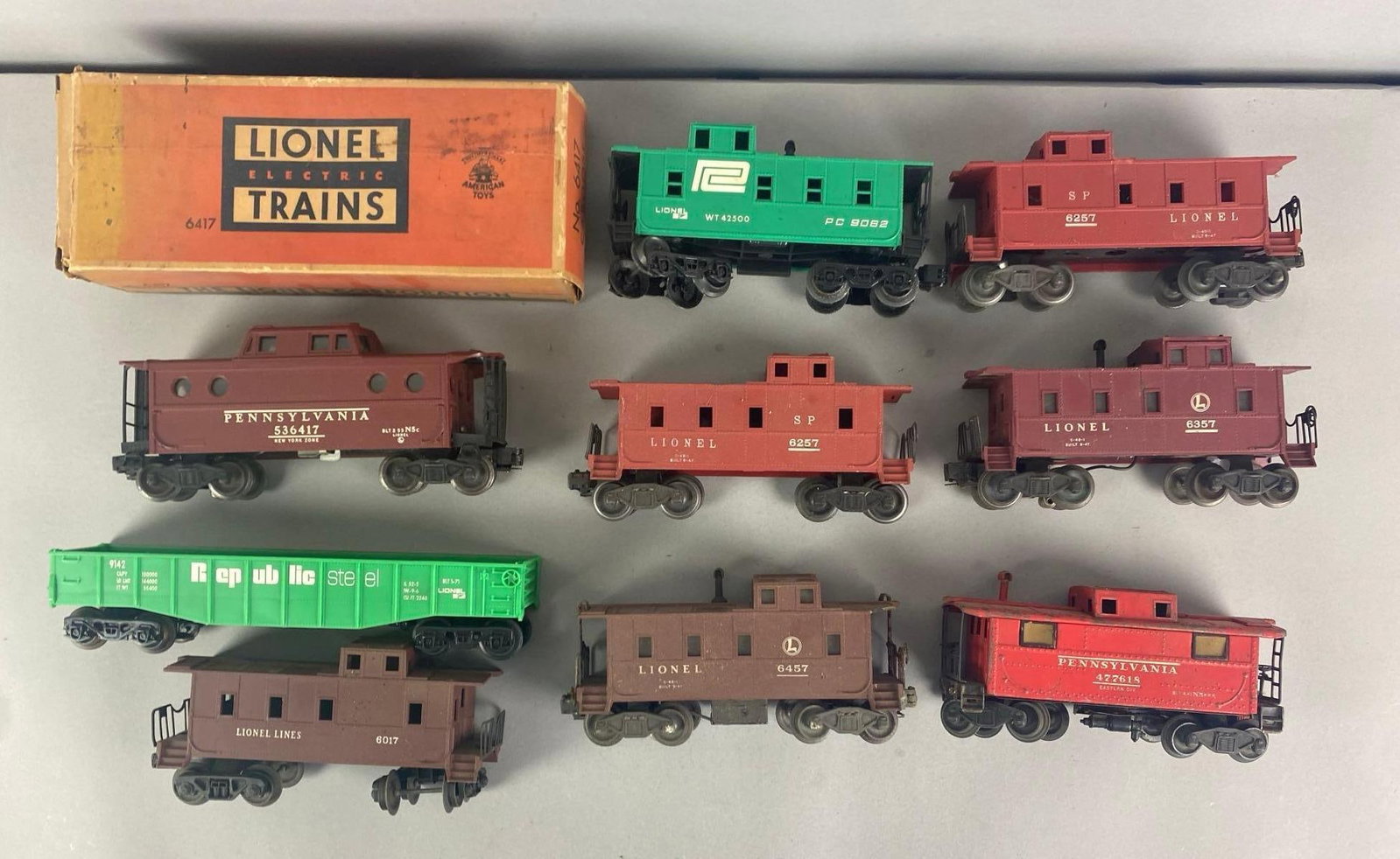 Group of Lionel O Scale Model Train Cars: Includes republic gondolas, Lionel caboose and box, longest car measures 11” W