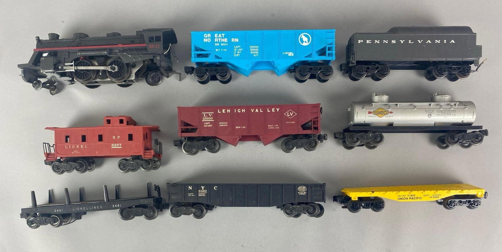 Group of Lionel O Scale Locomotive and Cars: Includes flatbeds, gondolas, caboose and more, locomotive measures 10” W
