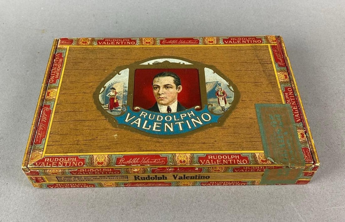 Vintage Rudolph Valentino Cigar Box: Wear consistent with age. Measures H 1 1/2 x W 9 1/4 x D 5 3/4 inches.