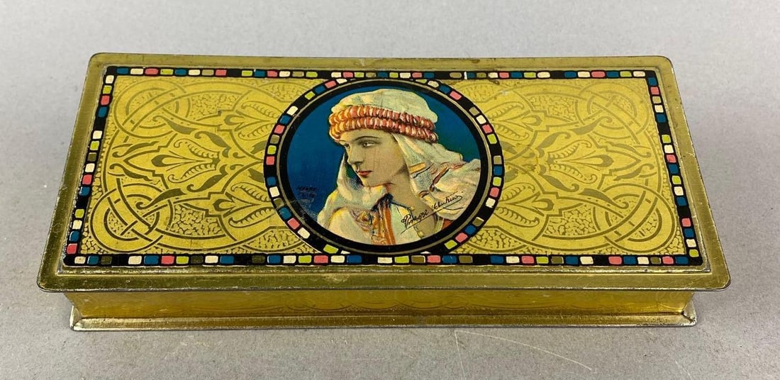 Vintage Rudolph Valentino Tin: Wear is consistent with age. Measure ms H 1 1/4 x W 8 x D 3 1/2 inches.