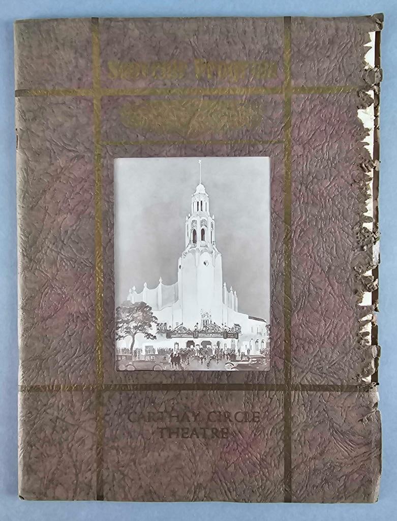 1926 Carthay Circle Theatre Premiere Souvenir Program: Given at its grand opening in 1926, Missing sections shown on edge of front cover. Measures 12 1/2 x 9 1/4 inches
