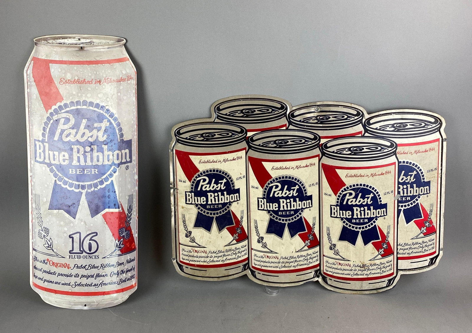 Group of 2 Pabst Blue Ribbon Advertising Beer Metal Signs: One has wear. Largest measures 16 1/2 x 22 1/2 inches.