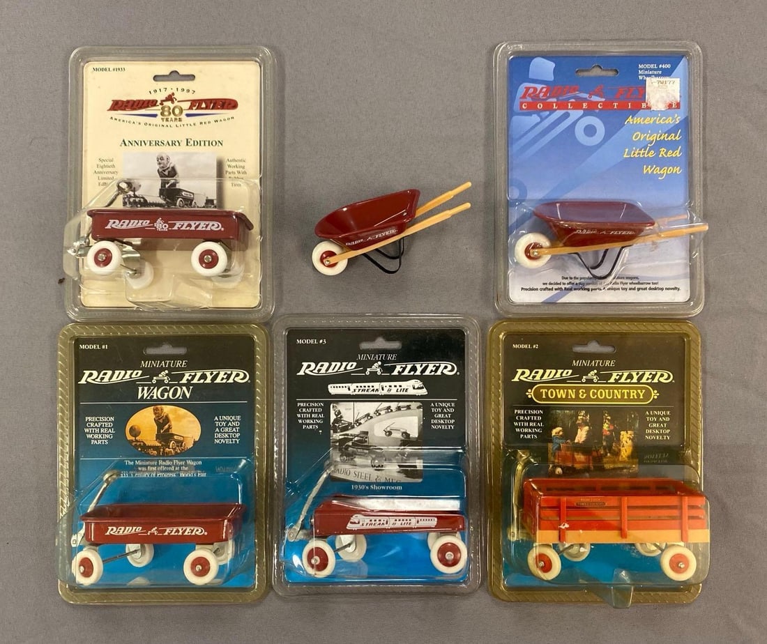 Group of Radio Flyer Die-Cast Wagons and Wheel Barrels: Largest measures 7 1/2” H x 5 1/2” W x 3” D