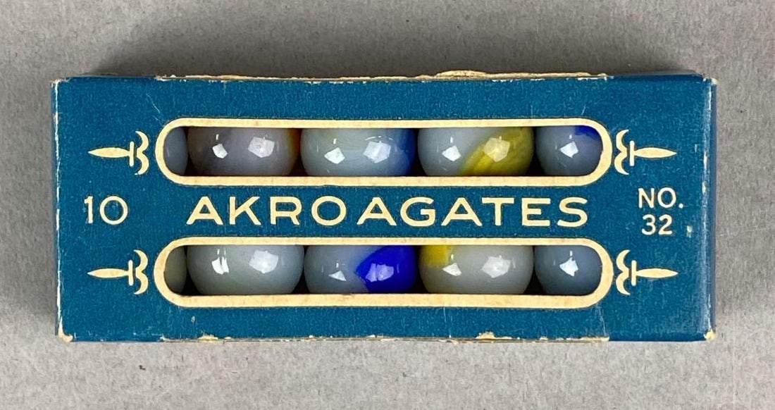 Vintage Box of Akro Agates No.32 Marbles: The Akro Agates Co. Clarksburg, West Virginia. Box measures H 3/4 x W 3 1/2 x D 1 1/2 inches.