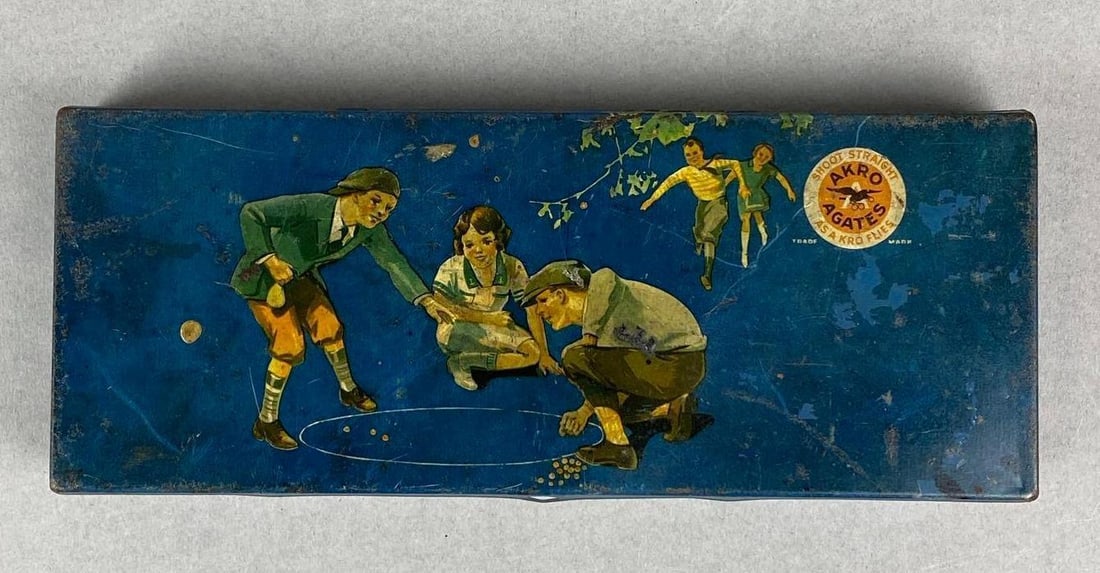 Antique Akro Agates No. 150 Tin: Measures H 1 x W 8 3/4 x D 3 3/4 inches.