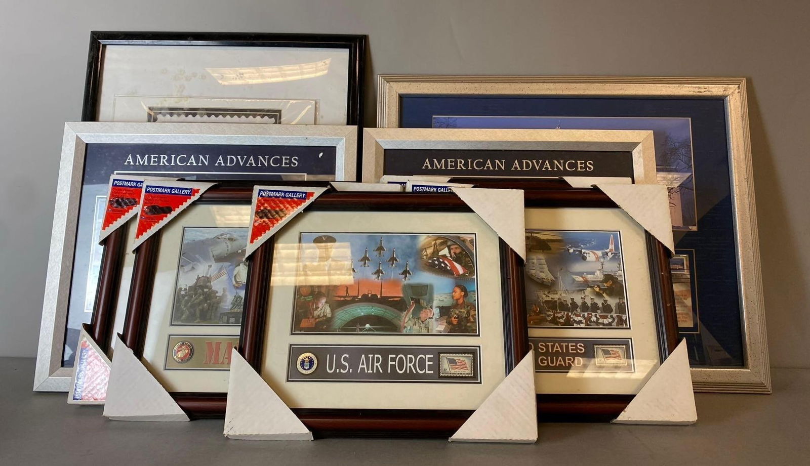 Group of 9 Military Frames and More: Includes 9/11 First Day of Issue Stamp, White House Stamps, and more. Largest frame measures H 18 1/2 x W 22 inches.