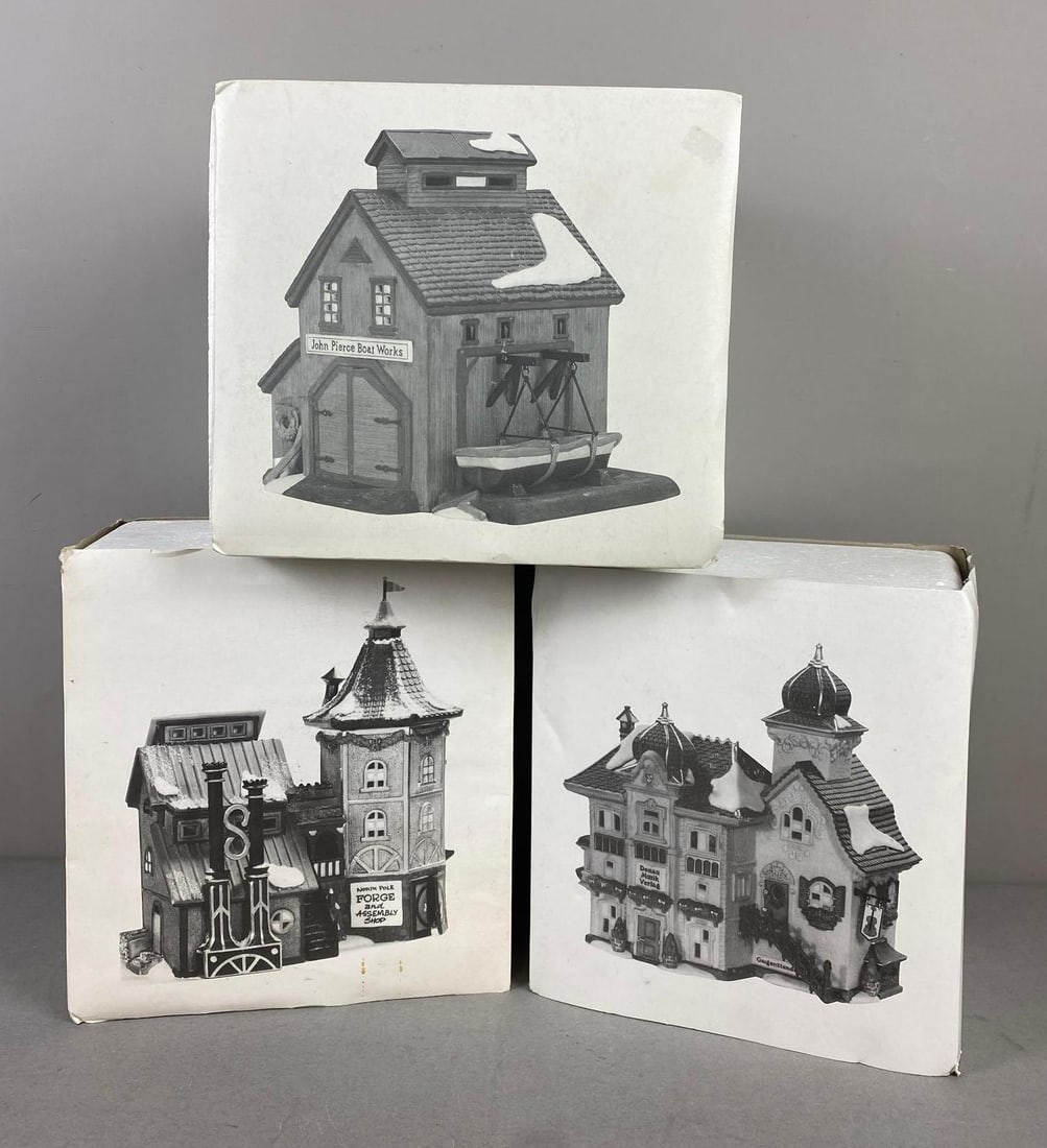Group of 3 Department 56 Heritage Village Collection Porcelain Buildings: Includes Danube Music Publisher, Elfin Forge & Assembly Shop, and Pierce Boat Works. Like new in original packaging. Largest item measures H 9 1/2 x W 9 x L 10.