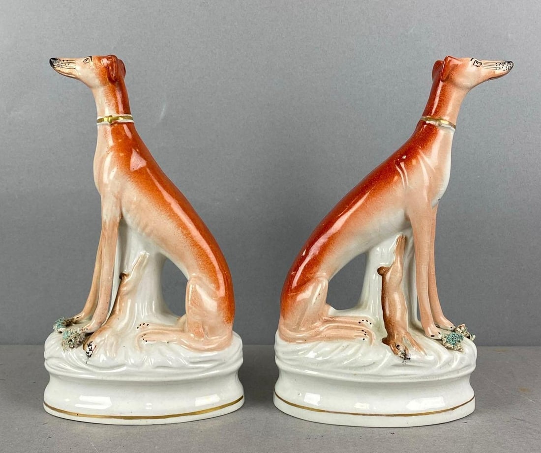 Antique Pair of Staffordshire Porcelain Whippet Dog Figurines: Both have crazing and one has a paint chip. Largest measures H 8 1/2 x W 5 x D 3 inches.