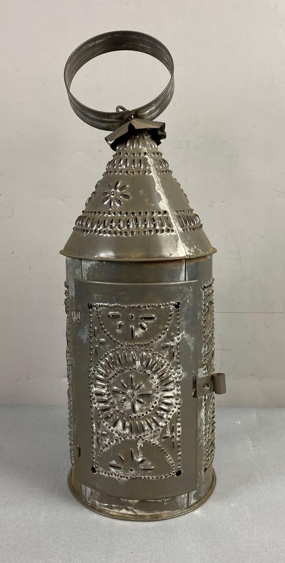 Replica Paul Revere Style Punched Tin Candle Lantern l: Circa 1950’s. Measures 17 inches tall. Has previous candle wax residue on bottom.