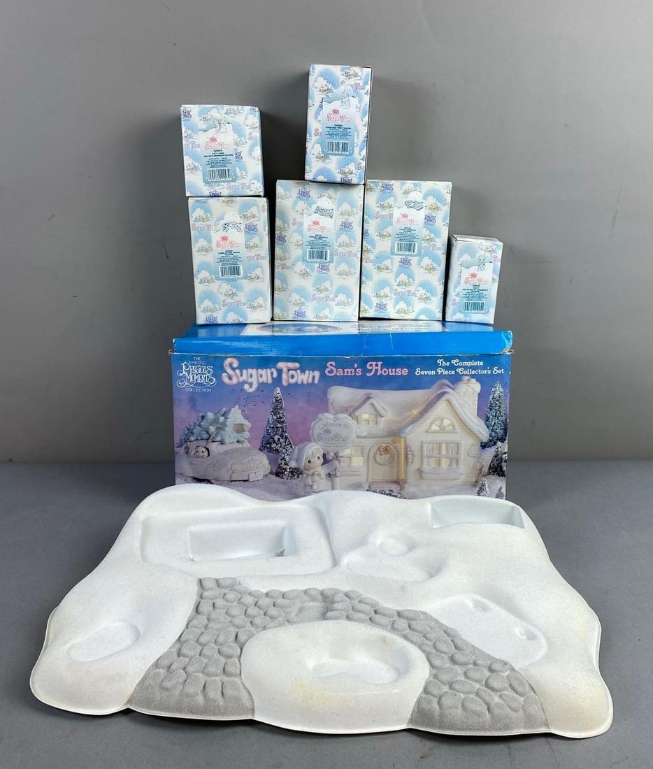 Group of 7 1996 Precious Moments Figures and More: Includes Sam’s house, Christmas tree, and more. Largest item measures L 14 x W 12 inches.