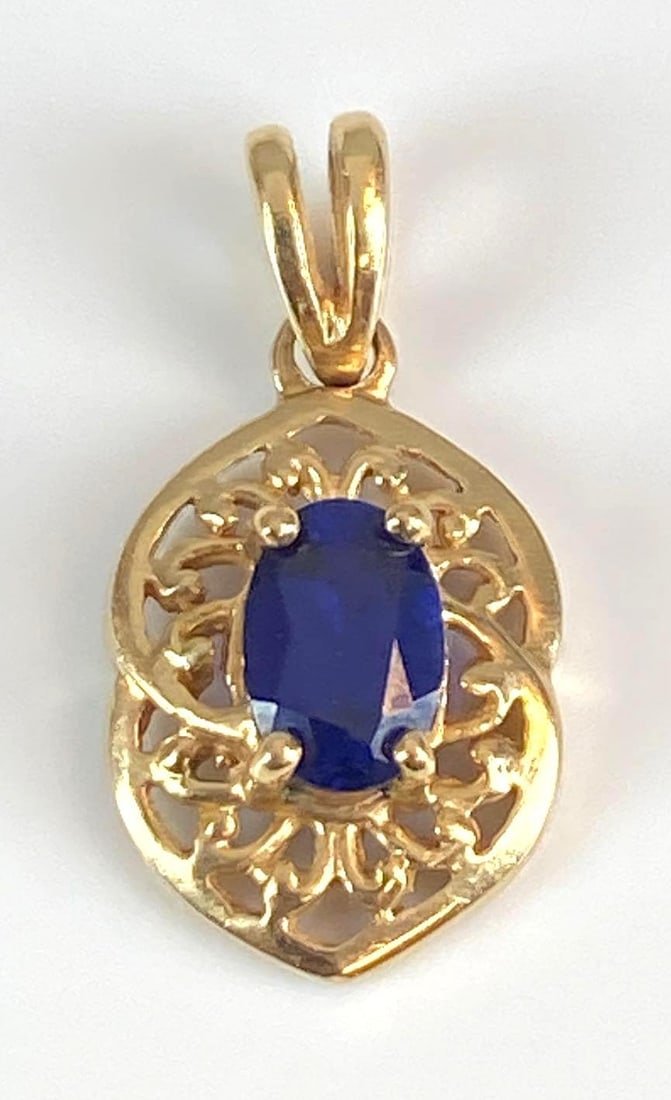 Signed 10K Yellow Gold Sapphire Pendant: Total weight of 1 grams, measures 3/4” H