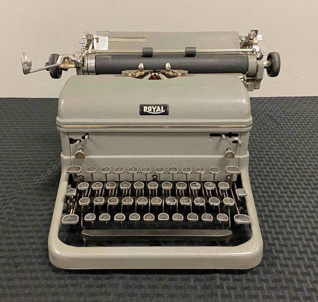 Vintage 1950 Royal KMG Typewriter: Includes Ribbon. Tested and working. Measures H 9 x W 10 x L 14 inches.