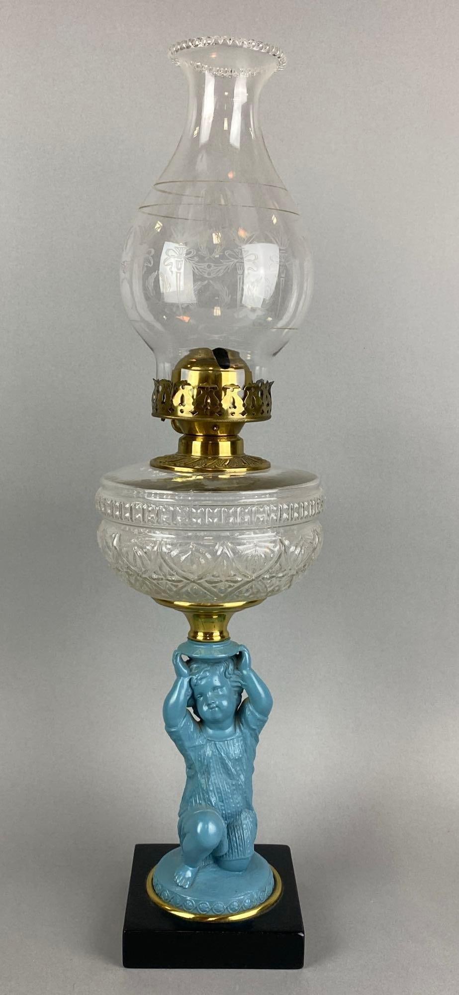 Antique Figural Child Oil Lamp: Chimney Bottom edge has a few chips. Measures 22 x 6 1/2 x 6 1/2 inches.