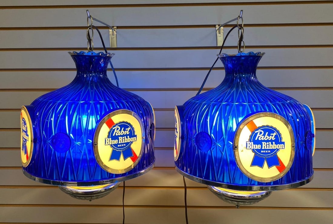 Group of 2 Pabst Blue Ribbon Beer Light Up Advertising Hanging Fixture: Crack on one blue ribbon badge. Working condition. One measures H 11 1/2 x W 13 x L 13 inches.