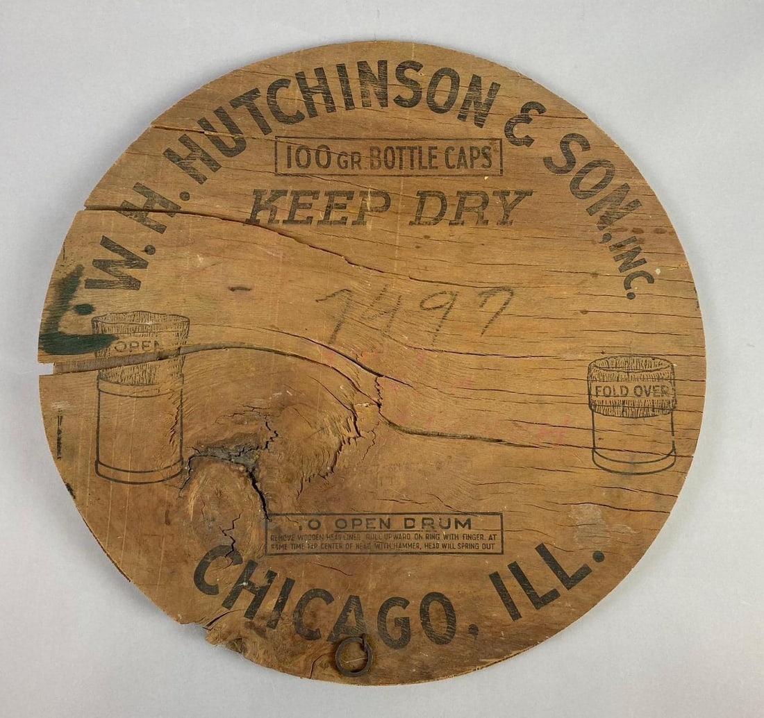 W. H. Hutchinson & Son Bottle Cap Drum Lid Advertising Display: Has multiple splits in wood. Measures 18” in diameter.