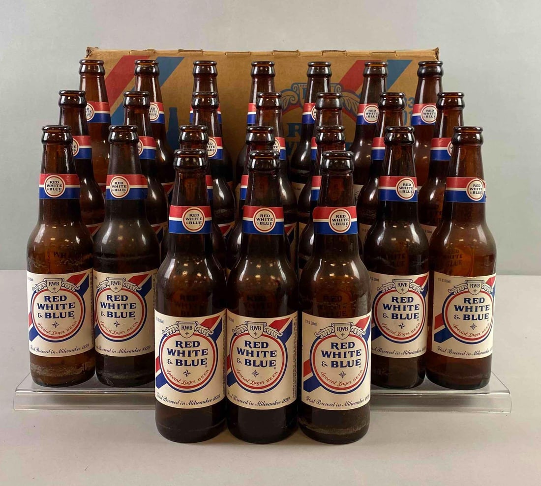 Group of 24 Red White And Blue Lager Beer Bottle With Box: Box has stain on top. No caps included. Stand not included. Box measures H 10 x W 11 x L 16 1/2 inches.