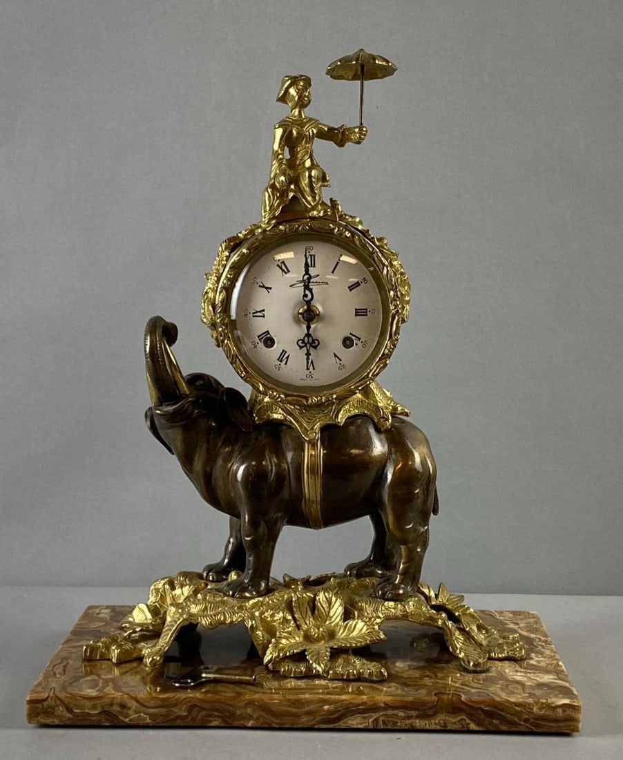 Vintage Italian Chinoiserie Bronze Elephant Mantle Clock: Working Condition. Both Chime and Movement work. Movement Made in Germany. Clock made in Italy. Base is removable. Measures H 15 x W 5 x L 11 inches.
