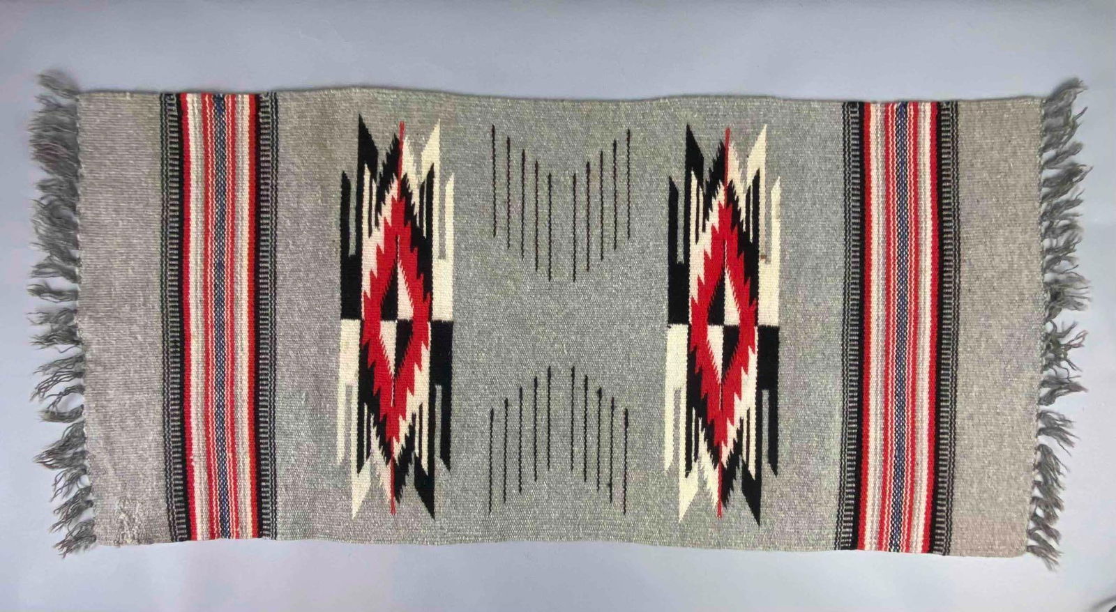 Vintage Native American Navajo Rug: Features Storm Warrior Pattern. Measures L 39 x W 17 inches.