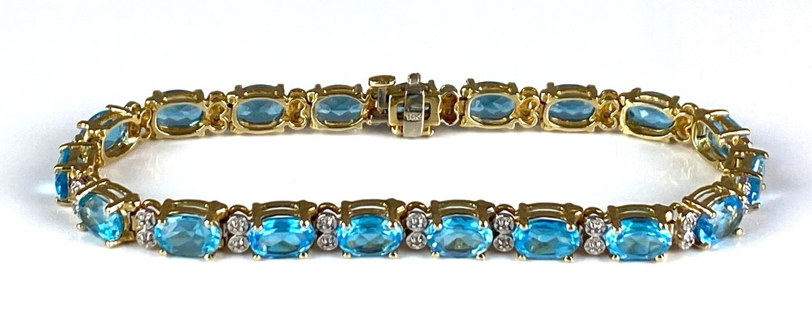 14K Yellow Gold Blue Topaz Bracelet: total weight of 15 grams, measures 7 1/4” In length