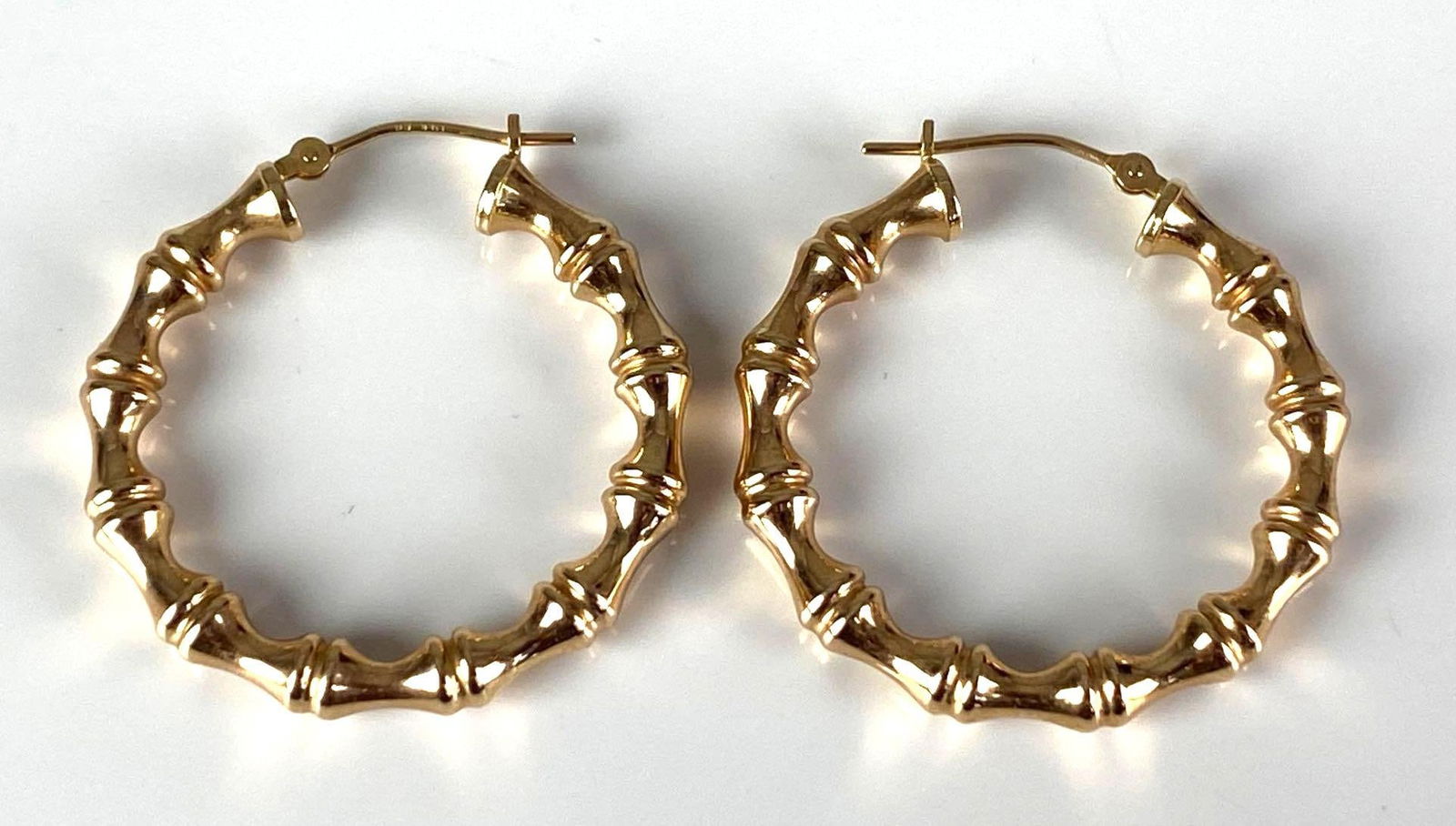 Signed EG 14K Yellow Gold Hoop Earrings: total weight of 2.3 grams, each measures 1 1/4” H x 1” W