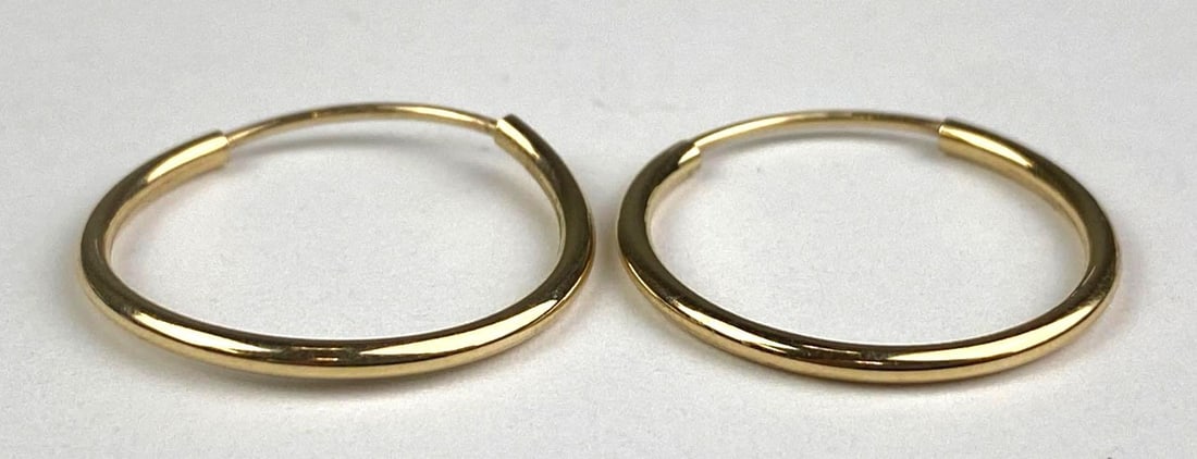 Pair of 14K Yellow Gold Hoop Earrings: total weight of 0.7 grams, measures 3/4” in diameter