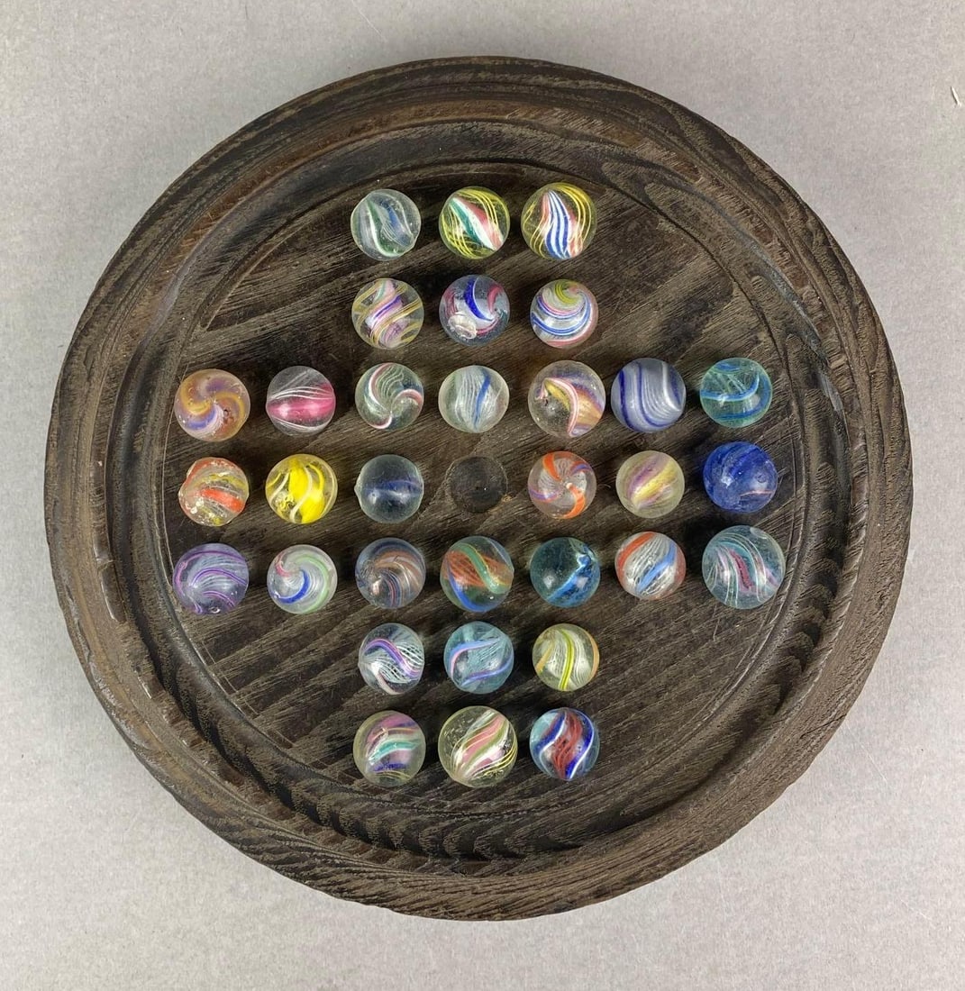 Antique Marble Solitaire Game with German Swirl Marbles: Largest marble measures .73 inches. Board measures H 2 x W 9 x D 9 inches