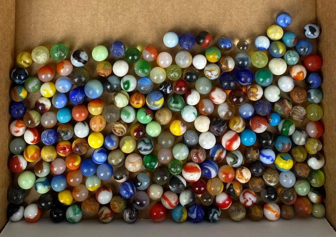 Group of Assorted Vintage Marbles: Some are chipped. Some are UV Light Reactive. Largest measures .73 inches.