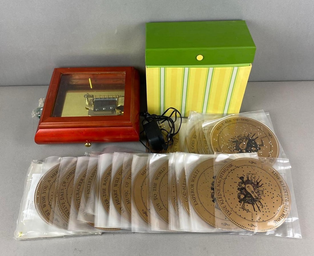 Mr. Christmas Holiday Symphonium and more: Untested. Includes adapter, plastic music discs and more. Largest item measures H 10 x W 10 1/2 x D 5 inches.