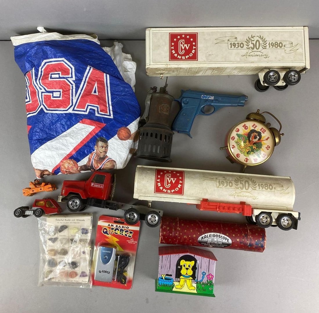 Group of Assorted Toys and More: Includes USA 1992 wind breaker, Tin Litho Bank, 007 toy gun and more. Largest item measures H 5 x W 20 x D 4 inches.