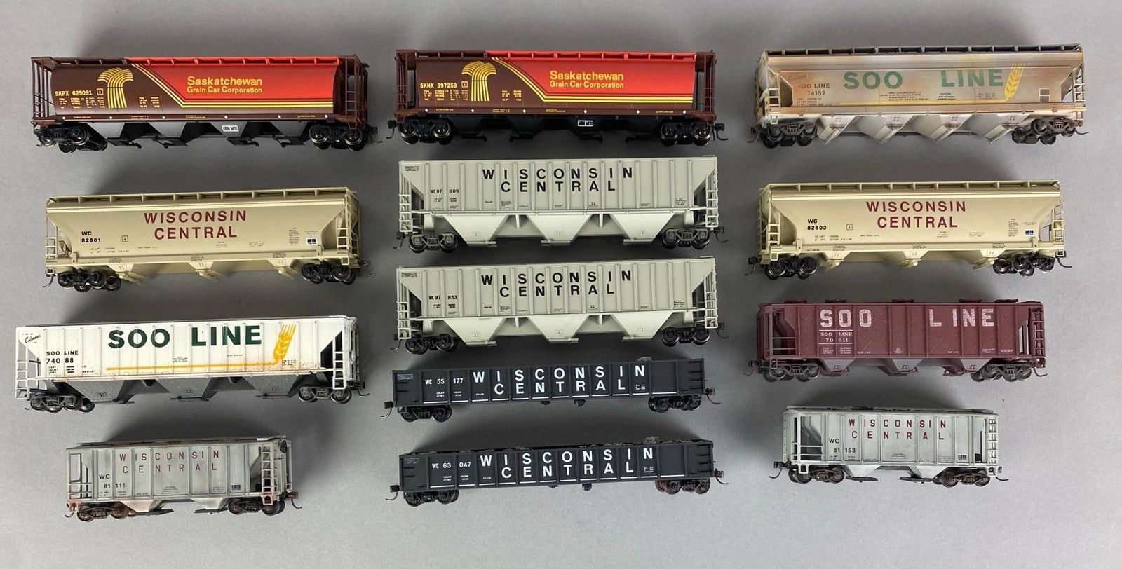 Group of HO Scale Model Train Cars: Includes Wisconsin central hoppers, SOO line hopper, Saskatchewan hoppers and more, longest measures 8? in length