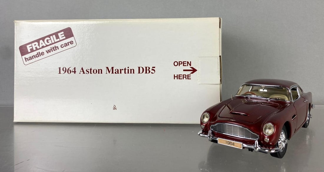 The Danbury Mint 1964 Aston Martin DB5 Die Cast Vehicle: Like new in original packaging. Circa 1990?s. Measures H 5 x W 5 x L 10 inches.