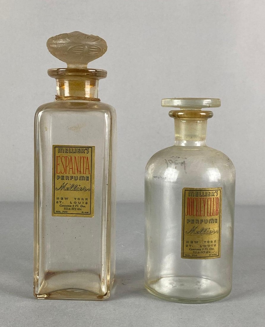 Group of 2 Antique Melliers 9 oz Perfume Glass Bottles: Includes Espanita and Jockey club, largest measures 8 1/2” H x 2 1/4” W x 2 1/4” D