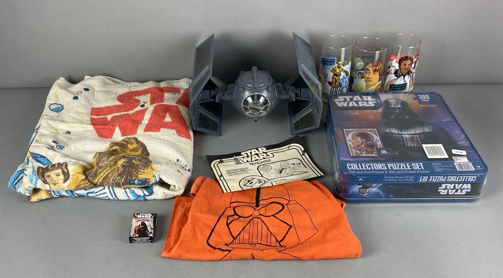 Group of Assorted Star Wars Items: Inclufes Tie-fighter, puzzle and more, puzzle box measures 10 1/2” H x 10 1/2” W x 3” D