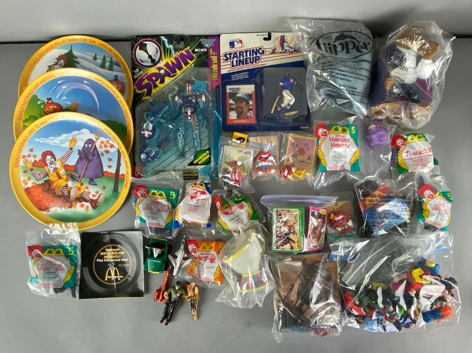 Group of McDonalds Toy Premiums and More: Includes Decorative plates, spawn Action figure, starting lineup baseball Figurine and more, plates measure 10” in diameter