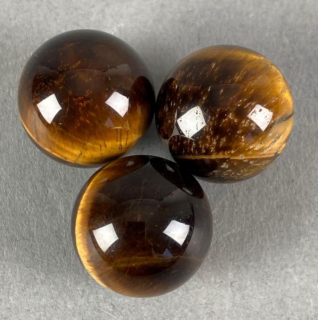 Group of 3 Tigers Eye Marbles with Leather Bag: Largest marble measures .79”