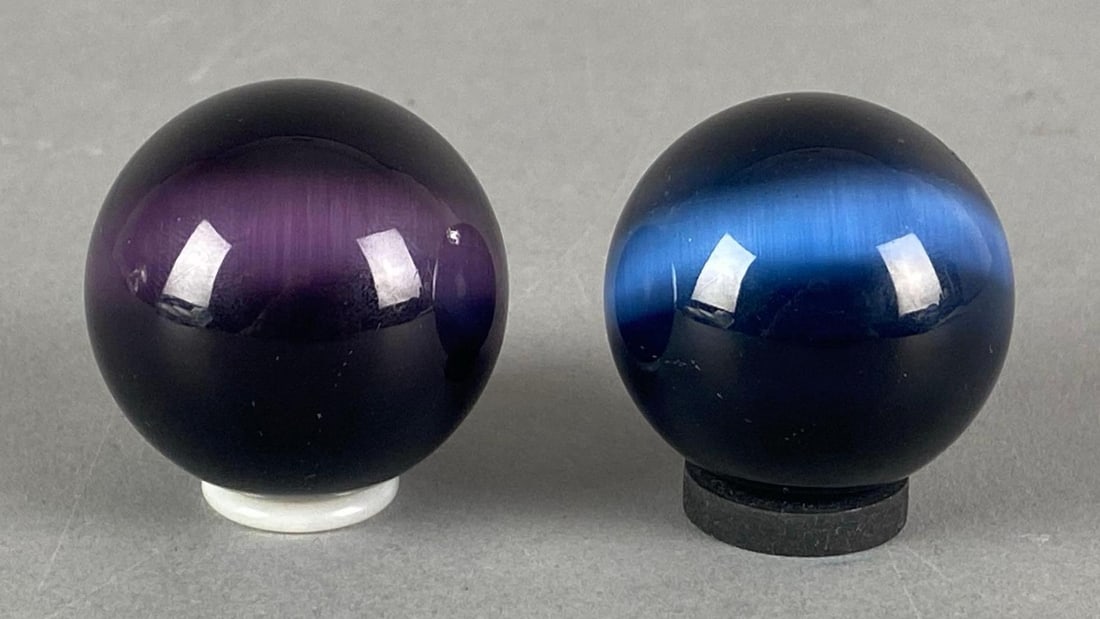 Group of 2 Tigers Eye Glass Marbles: Includes blue and dyed purple tigers eye, largest measures 1.5”