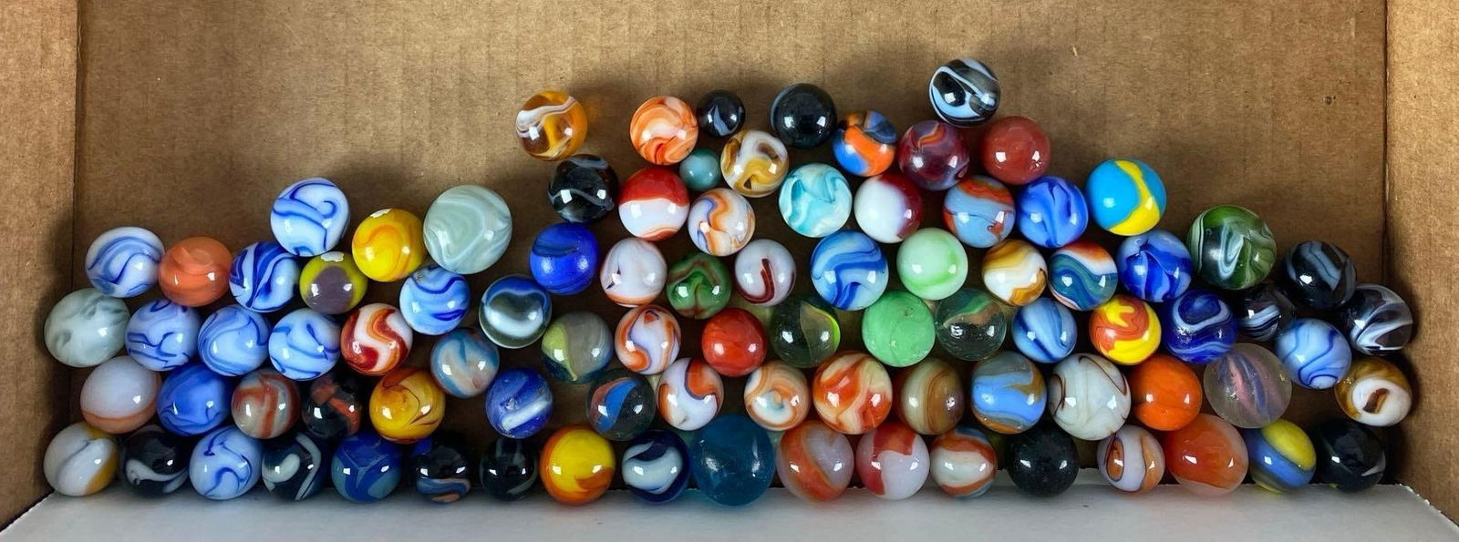 Group of 70+ Assorted Glass Marbles: largest measures .76”