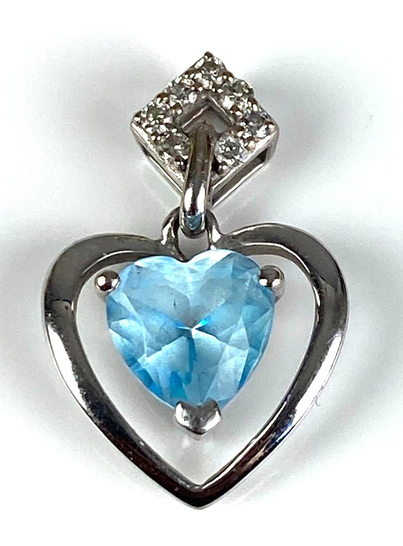 Signed 10K White Gold Diamond Sapphire Pendant: Total weight of 0.8 grams, measures 3/4” H x 1/2” W