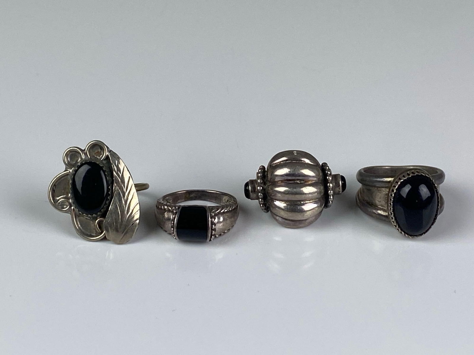 Group of 4 Sterling Silver Onyx Rings: One signed, Sizes range from 6 - 8 1/2