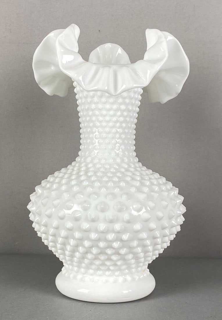 Fenton Hobnail Ruffled Ribboned Edge Milk Glass Vase: Marked on base, measures 10 1/2” H x 6 1/2” W x 6 1/2” D