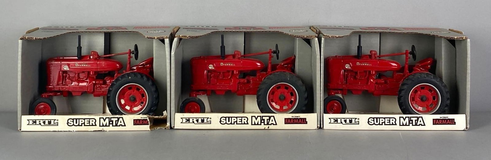 Group of 3 ERTL McCormick Super M-TA Tractors: 1/16 scale, die-cast, in original boxes