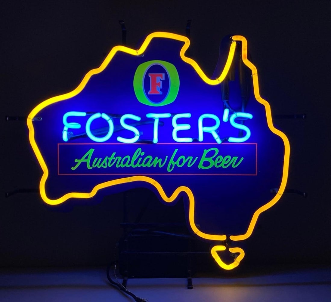 Fosters Australian For Beer Light Up Neon Advertising Sign: NO IN HOUSE SHIPPING AVAILABLE, THIRD PARTY SHIPPING RECOMMENDED, In working condition, rust shown on support cage and power supply, measures 23 1/2” H x 26” W x 6” D
