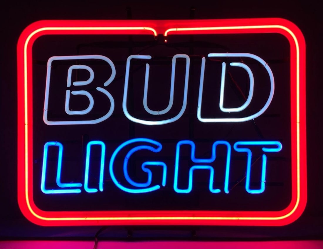 1991 Anheuser Busch Bud Light Light Up Neon Advertising Sign: NO IN HOUSE SHIPPING AVAILABLE, THIRD PARTY SHIPPING RECOMMENDED, In working condition, some splitting with wire shown on power cord, measures 21 1/2” H x 26 1/2” W x 7” D