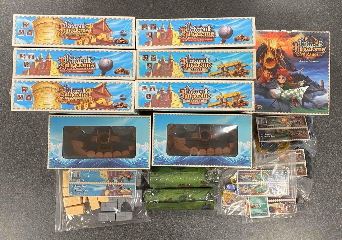 Group of Catapult Kingdoms Tabletop Game and More: Includes expansions and Accessories, most sealed, largest box measures 9” H x 9” W x 6 1/2” W