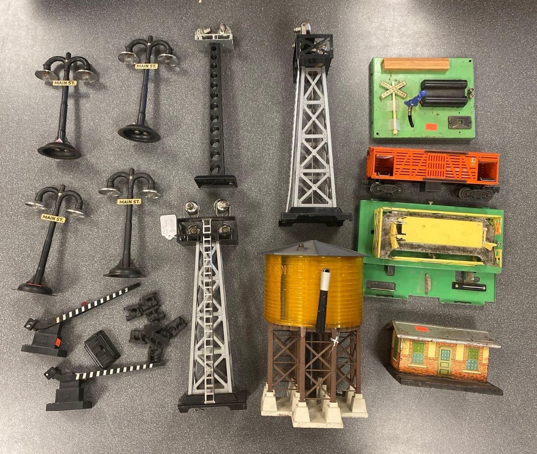 Group of Model Train Accessories and More: Includes cows, towers, street lights and more, largest measures 10 1/2” H x 6 1/2” W x 7” D