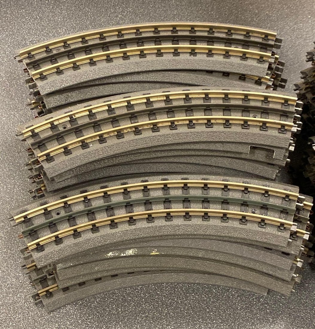 Group of MTH O Scale Electric Train Tracks: Includes sealed Operating I-31 switch and curved track sections, box measures 17” H x 9” W x 3 1/2” D