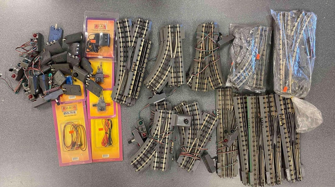 Group of MTH O Scale Track Switches and More: Inclufed wire harness’, control switches, control knobs and more, longest track switch measures 15” In length