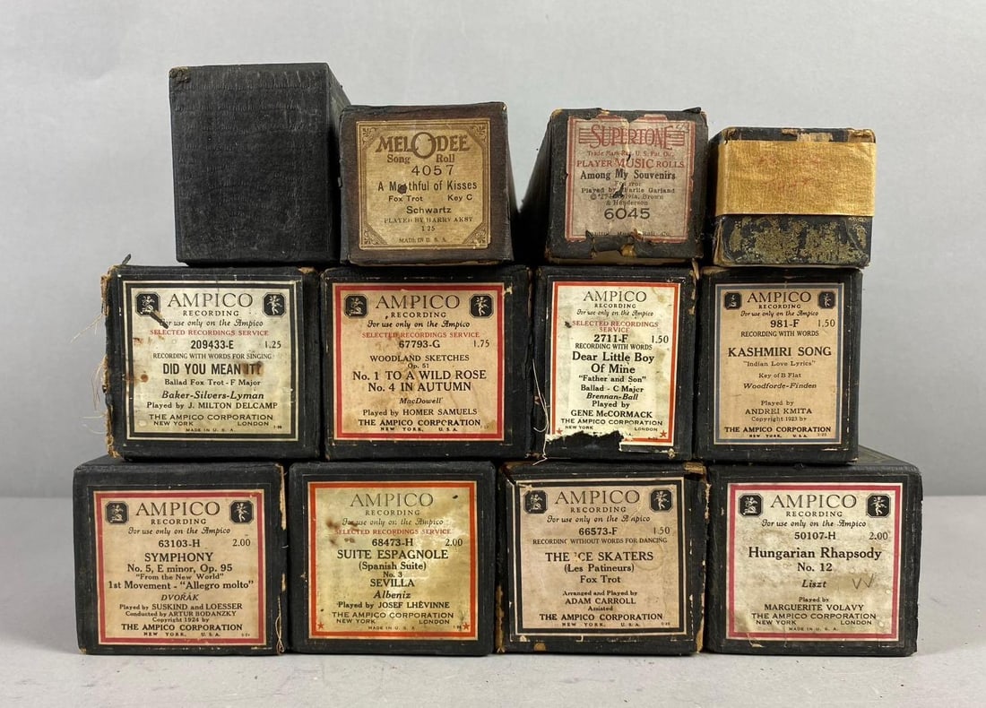 Group of 12 Ampico Recording Sheets Piano Rolls: Includes Hungarian Rhapsody, Kashmiri Song, and more. Largest measures H 3 x W 3 x L 12 1/2 inches.