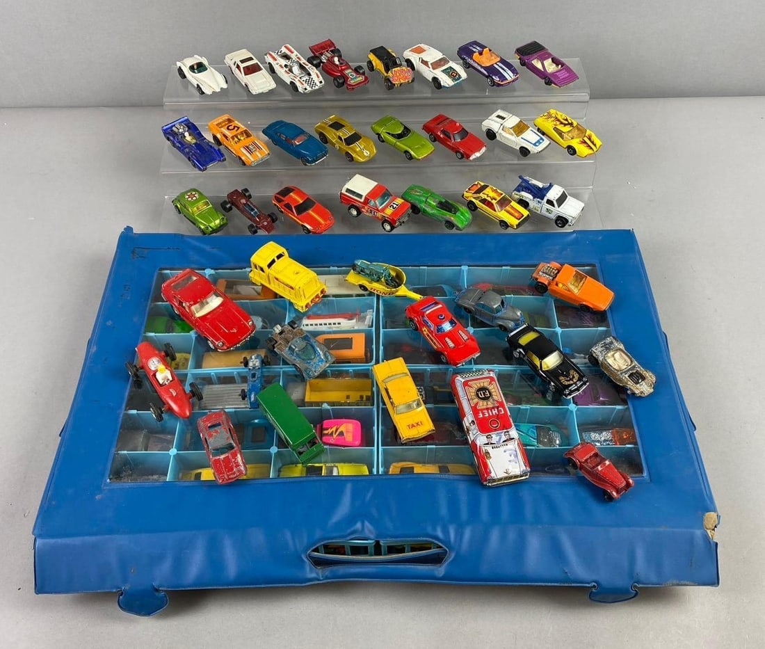 Group of Assorted Mattel Hotwheels Die Cast Vehicles and More: Including Corgi’s Toys Datsun 240z, Matchbox Dozer, and more. Largest car measures 4” in length. stand not included.